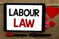 Handwriting text writing Labour Law. Concept meaning Employment Rules Worker Rights Obligations Legislation Union written on Table