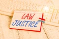 Handwriting text writing Law Justice. Concept meaning a scheme or system of law in which every demonstrating receives notebook Royalty Free Stock Photo
