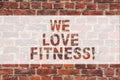 Handwriting text writing We Love Fitness. Concept meaning Having affection for sport exercises good healthy diet Brick