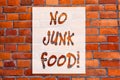 Handwriting text writing No Junk Food. Concept meaning Stop eating unhealthy things go on a diet give up burgers fries Brick Wall