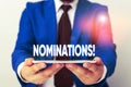 Handwriting text writing Nominations. Concept meaning action of nominating or state being nominated for prize Businessman in blue