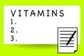 Handwriting text writing Vitamins. Concept meaning group of organic compounds which are essential for normal growth Royalty Free Stock Photo