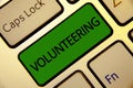 Handwriting text writing Volunteering. Concept meaning Provide services for no financial gain Willingly Oblige Keyboard green key