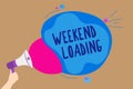 Handwriting text writing Weekend Loading. Concept meaning Starting Friday party relax happy time resting Vacations Man holding Meg