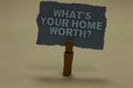 Handwriting text writing What s is Your Home Worth question. Concept meaning Value of a house Property Cost Price Rate Paperclip r