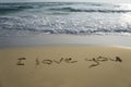 Handwriting word I love you on the sand