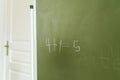 Handwritted mathematics example on the green chalkboard