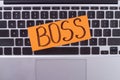 Handwritten boss word on laptop computre keyboard.