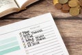 Handwritten Christian to-do list in notebook with money and open holy bible