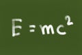 Handwritten formula E=mc2 on Green chalkboard or blackboard texture. illustration physics massÃ¢â¬âenergy equivalence formula. Back Royalty Free Stock Photo