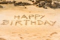 Soft yellow sand and a handwritten happy birthday Royalty Free Stock Photo