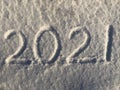 Handwritten inscription on snow 2021. Happy New Year. Background, white.