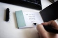 Handwritten inscription work from home with a picture of a heart in a notebook on a white background with a keyboard