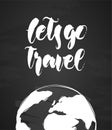 Handwritten lettering of Let`s go Travel and hand drawn Earth on chalkboard background