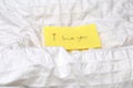 Handwritten little yellow note with the words I love you on white sheets on a bed, romantic concept valentines day