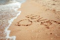 Handwritten Love Word on the Sand Coast. Wonderful words on beach sand. Love idea concept Royalty Free Stock Photo