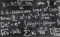 Handwritten mathematical formulas on blackboard written.
