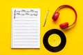 Handwritten music sheets and headphones, top view. Compose music concept