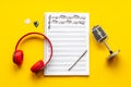 Handwritten music sheets and headphones, top view. Compose music concept