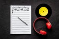 Handwritten music sheets and headphones, top view. Compose music concept