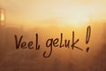 Lettering Netherlandish language text Veel geluk is Good luck in english message written finger on foggy glass wet Royalty Free Stock Photo