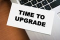 A handwritten note displaying the phrase TIME TO UPGRADE rests on a laptops keyboard, emphasizing renewal and innovation Royalty Free Stock Photo