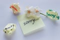 Handwritten note - I`m Sorry. Small delicate white flowers of al