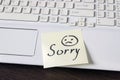 Handwritten note is on the keyboard. - Sorry. Sad smiley face dr