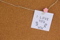 Handwritten note left with pink flowered mandalla on cork board