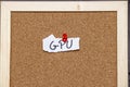 Handwritten note saying GPU pinned to corkboard with a red pushpin. Ideal for topics related to technology, computing, o Royalty Free Stock Photo