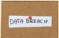 A handwritten note on a white paper labeled DATA BREACH pinned to a corkboard. This conveys issues of security and priva Royalty Free Stock Photo