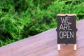 Handwritten Open sign on table in open-air cafe