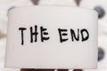 Handwritten phrase THE END on a roll of toilet paper. This image symbolizes closure or finality in various contexts, per Royalty Free Stock Photo