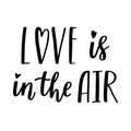 The handwritten phrase Love is in the air. Hand lettering. Words on the theme of Valentine's Day. Black and white vector Royalty Free Stock Photo