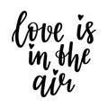 The handwritten phrase Love is in the air. Hand lettering. Words on the theme of Valentine`s Day. Black and white vector Royalty Free Stock Photo