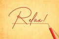 Handwritten Relax Word On Vintage Yellow Paper. Old Textured Paper with red pencil Writing Relax! message Signature With red