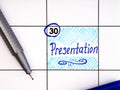 Handwritten reminder Presentation in the calendar with a blue pen