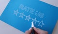Handwritten review rate us and star rating on blue background Royalty Free Stock Photo