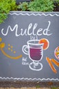 Handwritten sign mulled and simple drawing of a mulled wine glass with orange and cinnamon. Original advertisements attracting