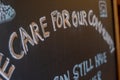 A handwritten sign at a pub saying care for our community as pubs and restaurants begin to open again as the covid lockdown eases Royalty Free Stock Photo