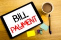 Handwritten text caption showing Bill Payment. Business concept writing for Billing Pay Costs Written on tablet laptop, wooden bac