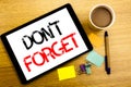 Handwritten text caption showing Do Not Forget. Business concept writing for Don t memory Remider Written on tablet laptop, wooden Royalty Free Stock Photo