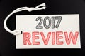 Handwritten text caption showing 2017 Review. Business concept writing for Annual Summary Report written on price tag paper on the