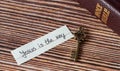 A handwritten text with a rustic vintage old key and closed Holy Bible Book on a wooden table. Royalty Free Stock Photo