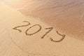 2019 handwritten text on sandy beach with flush wave