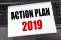 Handwritten text showing Action Plan 2019. Business concept writing for Success Strategy written on notepad note paper on the blac Royalty Free Stock Photo