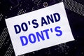 Handwritten text showing Do s And Do Not Donts. Business concept for Guide Allowed Written on sticky note, computer main board bac