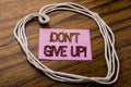 Handwritten text showing Don t Give Up. Business concept for Motivation Determination, written on sticky note paper on the dark wo