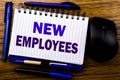 Handwritten text showing New Employees. Business concept for Welcome Staf Recruiting written on notebook book note paper on the wo Royalty Free Stock Photo