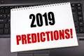 Handwritten text showing 2019 Predictions. Business concept writing for Forecast Predictive written on notepad note paper on the b Royalty Free Stock Photo